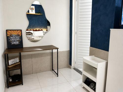a room with a table and a guitar on the wall at Ninho do Vale - Centro Conservatória in Conservatória