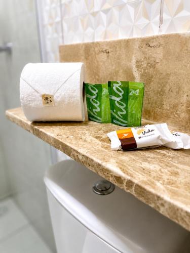 two rolls of toilet paper sitting on top of a counter at Pousada Maragobeach Suits in Maragogi