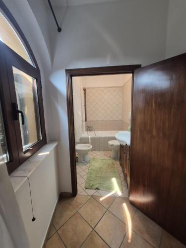 a bathroom with a toilet and a sink at La casina dei nonni in Sinalunga