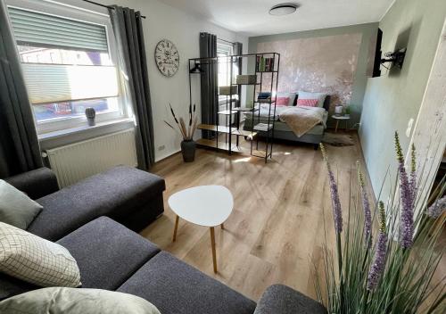 a living room with a couch and a table at Apartment -Zur Oehla in Ilmenau