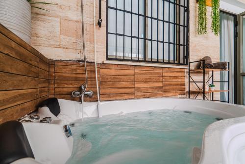 a bath tub filled with water in a room at חופשה בממלכה in Ashkelon