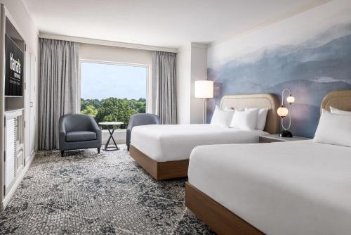a hotel room with two beds and a window at Harrah's Metropolis Hotel & Casino - A Caesars Rewards Destination in Metropolis