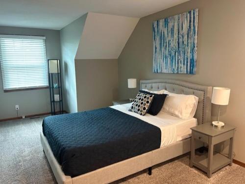 a bedroom with a large bed and a window at The Welcome Home in Topeka