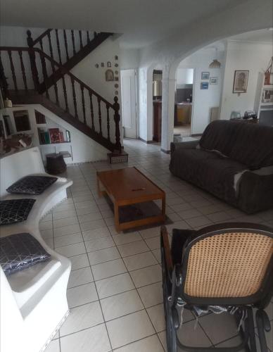 a living room with a couch and a coffee table at Maison tarnos in Tarnos