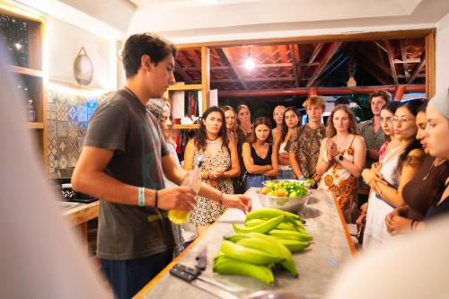 a group of people standing around a table with bananas at Casa Wolaba in Puerto Viejo