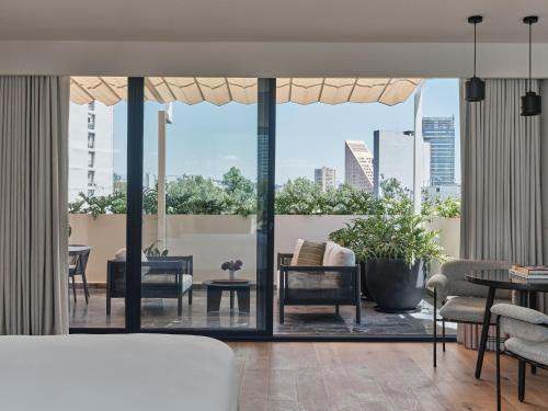 a living room with a view of a city at Kimpton El Castelar Polanco by IHG in Mexico City