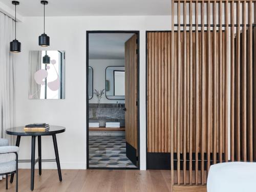 a room with a door with a table and a mirror at Kimpton El Castelar Polanco by IHG in Mexico City