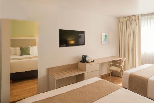 מיטה או מיטות בחדר ב-Stanza Hotel