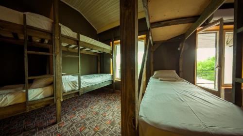 a room with two bunk beds and a window at Camp & Hostel Maltakva in Poti