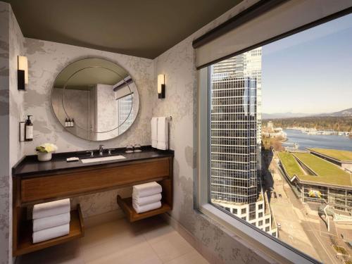 a bathroom with a sink and a large window at Fairmont Waterfront in Vancouver
