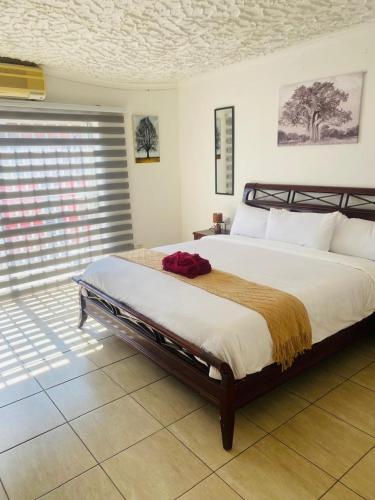 a bedroom with a large bed and a window at Royal Inn Boutique Lodge in Gaborone