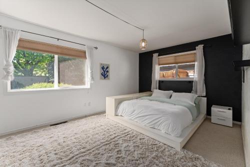 a bedroom with a white bed and a window at Baskets, Brews & Views: Epic Wenatchee Escape! in Wenatchee