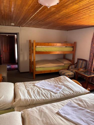a bedroom with two bunk beds and a chair at Ritrovo Neggia in Vira