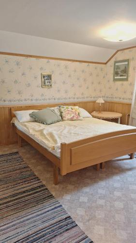 ein Schlafzimmer mit einem großen Bett in einem Zimmer in der Unterkunft Tyynelä in Juupajoki