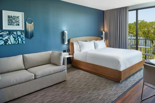 a hotel room with a bed and a couch at Element by Marriott Bainbridge Riverfront in Bainbridge