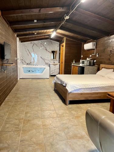 a bedroom with a bed and a bath tub at Good Time 99 in Shezor