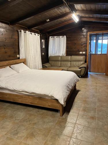 a bedroom with a large bed and a couch at Good Time 99 in Shezor