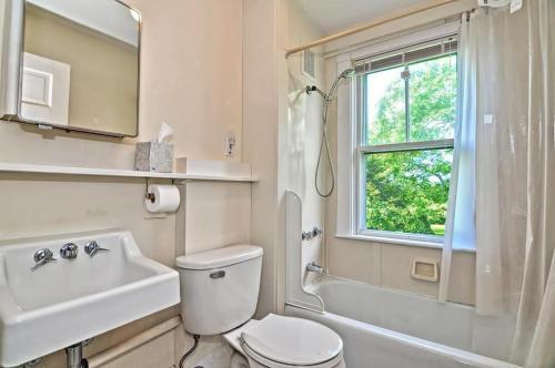 a bathroom with a toilet and a sink and a window at Westport Point Farmhouse in Westport Point
