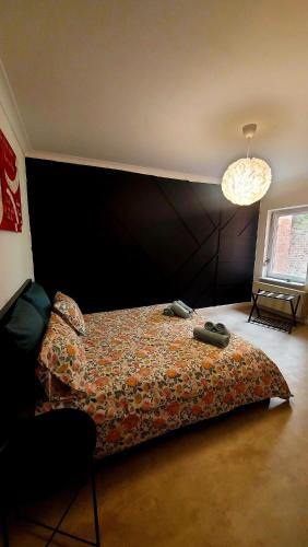 a bedroom with a bed with a head board at Maison Marthe in Sint-Truiden