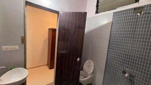 a bathroom with a toilet and a sink and a shower at The Golden palace in Paratwāda