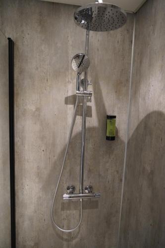 a shower with a shower head in a bathroom at Birtavarre Aurora Adventures in Birtavarre