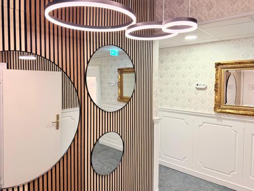 a bathroom with a round mirror and a sink at HPA Hotel Andreas in Vienna
