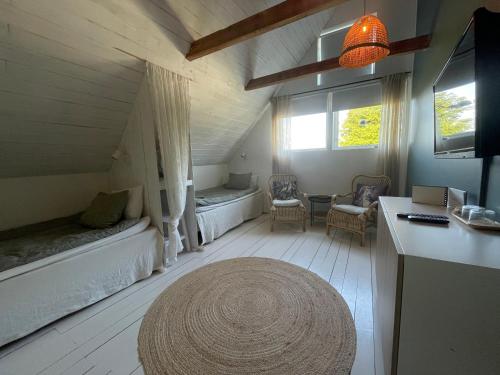 a living room with two beds and a table at Galleriet BnB in Stenkyrka