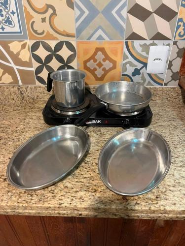 two metal pans sitting on a stove in a kitchen at Areal in Areal
