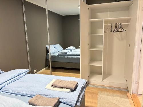a bedroom with two beds and a mirror at Leknestunet in Vestvågøya