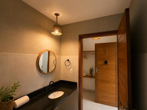 a bathroom with a sink and a mirror at Villa Vinci Flat in São Miguel do Gostoso