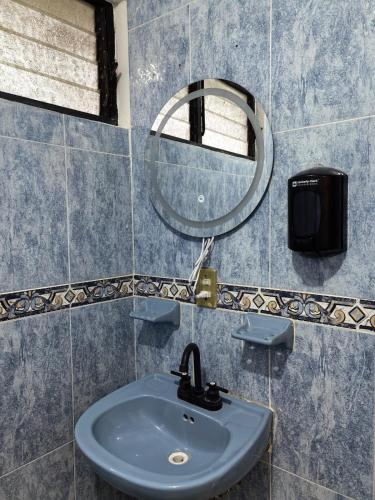 a bathroom with a sink and a mirror at Casa Cariño in San Cristóbal de Las Casas