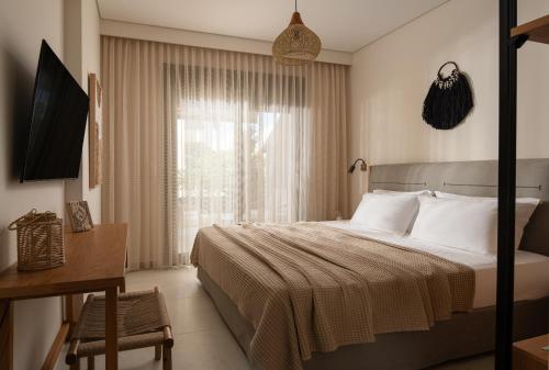 a hotel room with a bed and a window at DARION Residence in Nikiti
