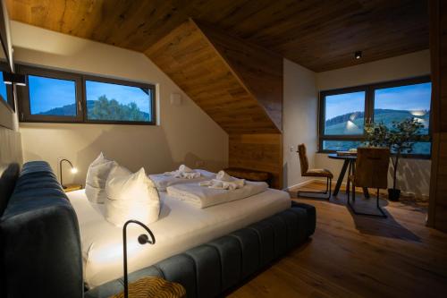 a bedroom with a bed in a room with windows at SAUERLAND CHALETS - "Die Chalets Lieblingsplatz" in Winterberg