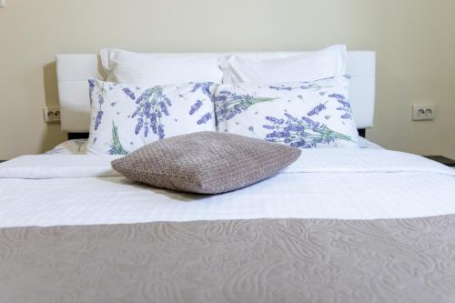 a bed with a pillow sitting on top of it at Casa SEMA in Sinaia