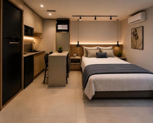 a bedroom with a large bed and a kitchen at Ecobox in Santa Rosa