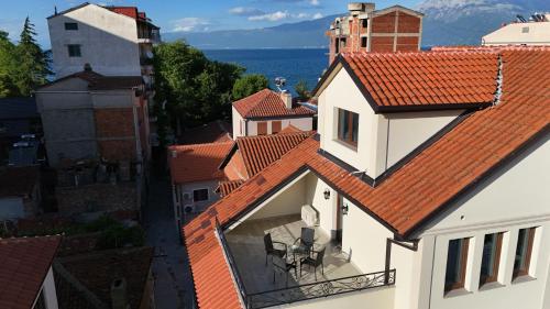 a view of a white building with a red roof at Tomas Inn in Pogradec