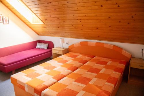 a bedroom with a bed and a couch at Privat Kovacova in Žiar