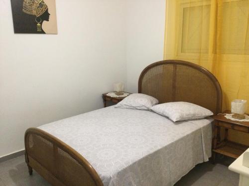 a bedroom with a bed with two pillows on it at Villa Hibiscus in Bouillante