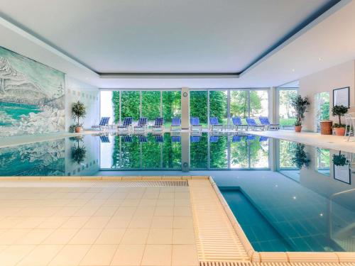 an indoor pool with a view of the water at Sunday Hotel Garmisch Partenkirchen in Garmisch-Partenkirchen