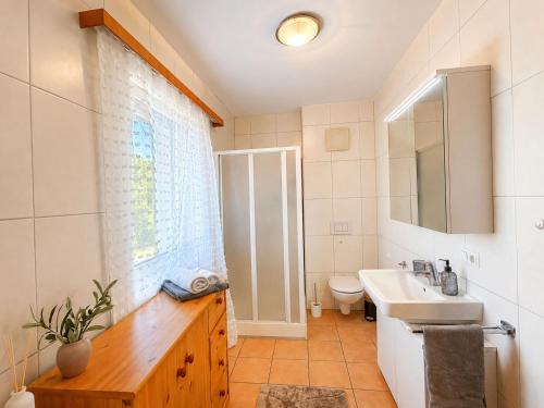 a bathroom with a sink and a toilet at Faraway Homes Studios Eberstalzell in Eberstalzell