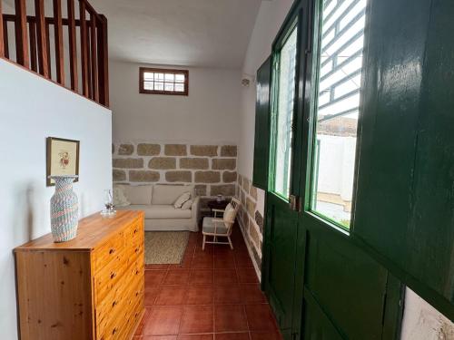 a living room with a green door and a couch at The Hidalga's cozy house in Arafo