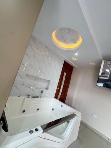 a bathroom with a white sink and a ceiling at Inti killa in Huánuco