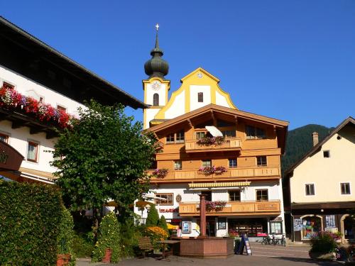 a building with a clock tower on top of it at Dorfappartements Söll in Söll