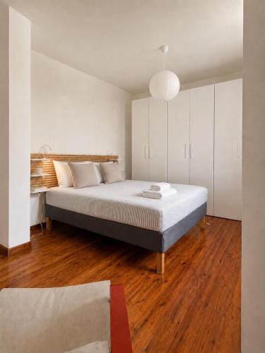 a bedroom with a large bed with white cabinets at Venzone dalla Finestra in Venzone