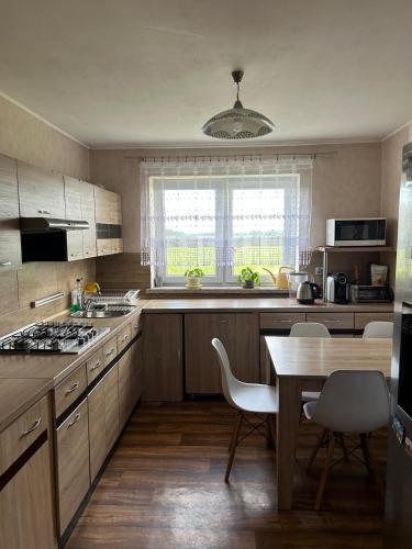 a kitchen with a table and chairs and a table and a dining room at U Leona in Przeciszów