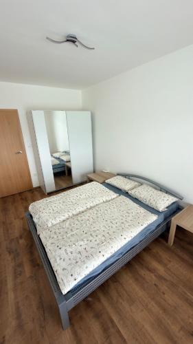 a bedroom with two beds and two mirrors at Moderní apartmán Boskovice in Boskovice