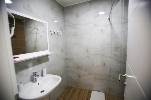 a bathroom with a sink and a mirror at Vila Lago Verde in Zvornik