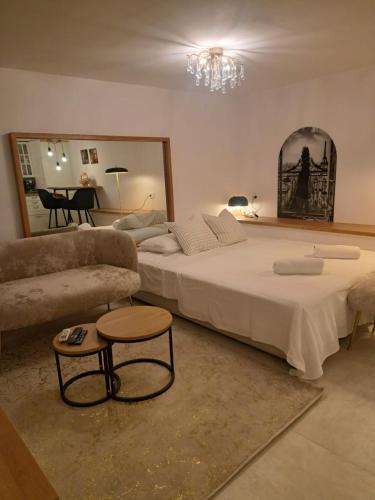 a large bedroom with a large bed and a couch at Luni Studio Apartment with garden in Kaštela