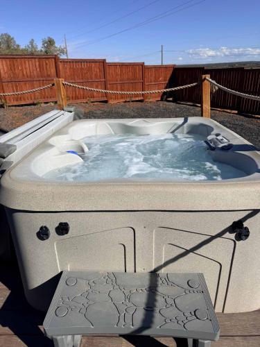 a jacuzzi tub sitting on top of a yard at Zion Tiny Home, Private Hot Tub, Near Trails in Apple Valley