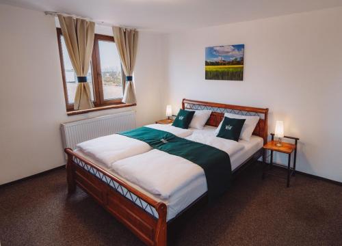 a bedroom with a large bed and a window at U Císaře Rudolfa in Mělník